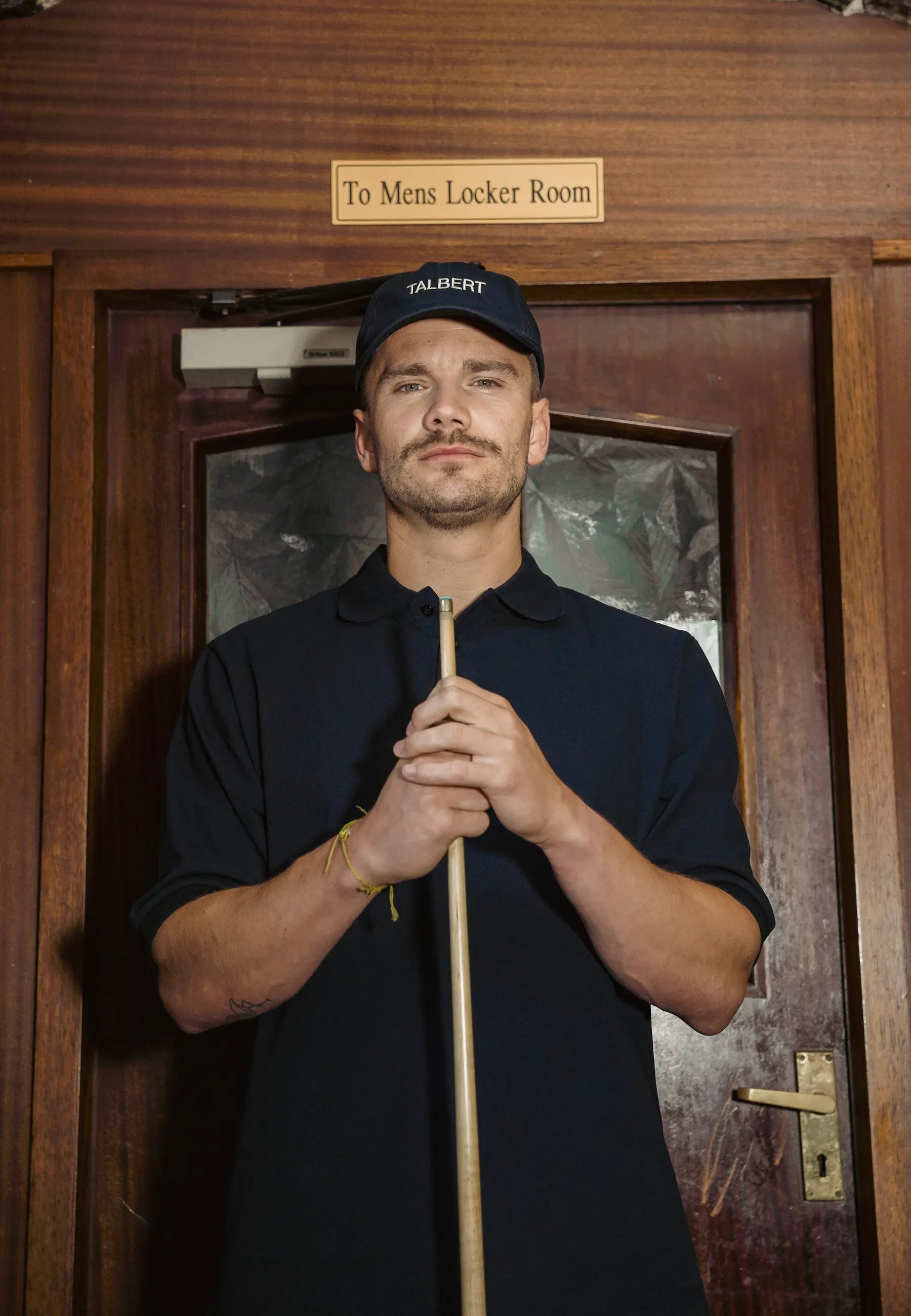 Close-up of Talbert Golf 001 Cap and Polo in navy with embroidered logo
