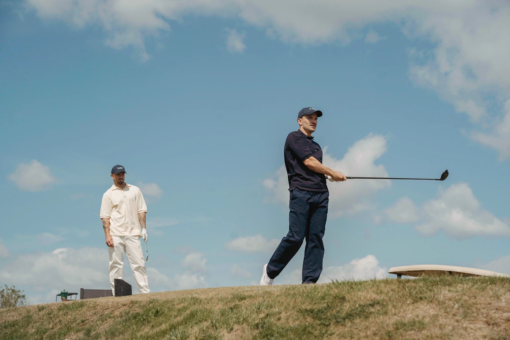 Models wearing Talbert Golf 001 Polo in cream and navy on the golf course