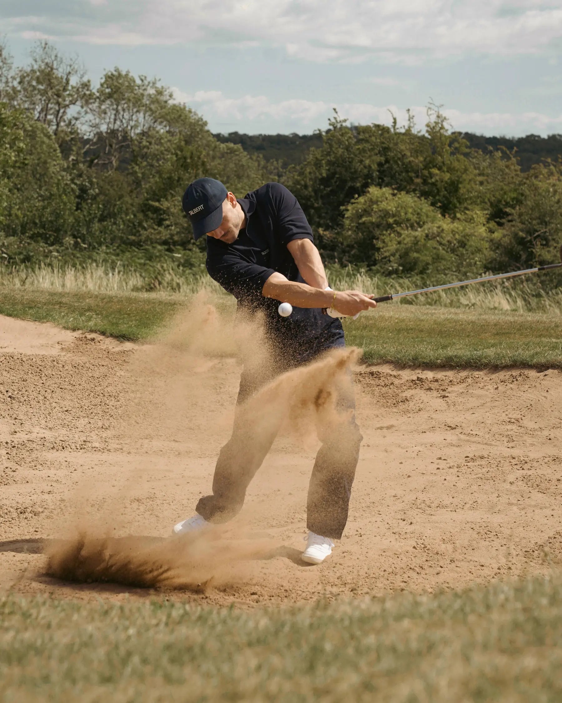 Model wearing Talbert Golf 001 Polo in 
navy on the golf course