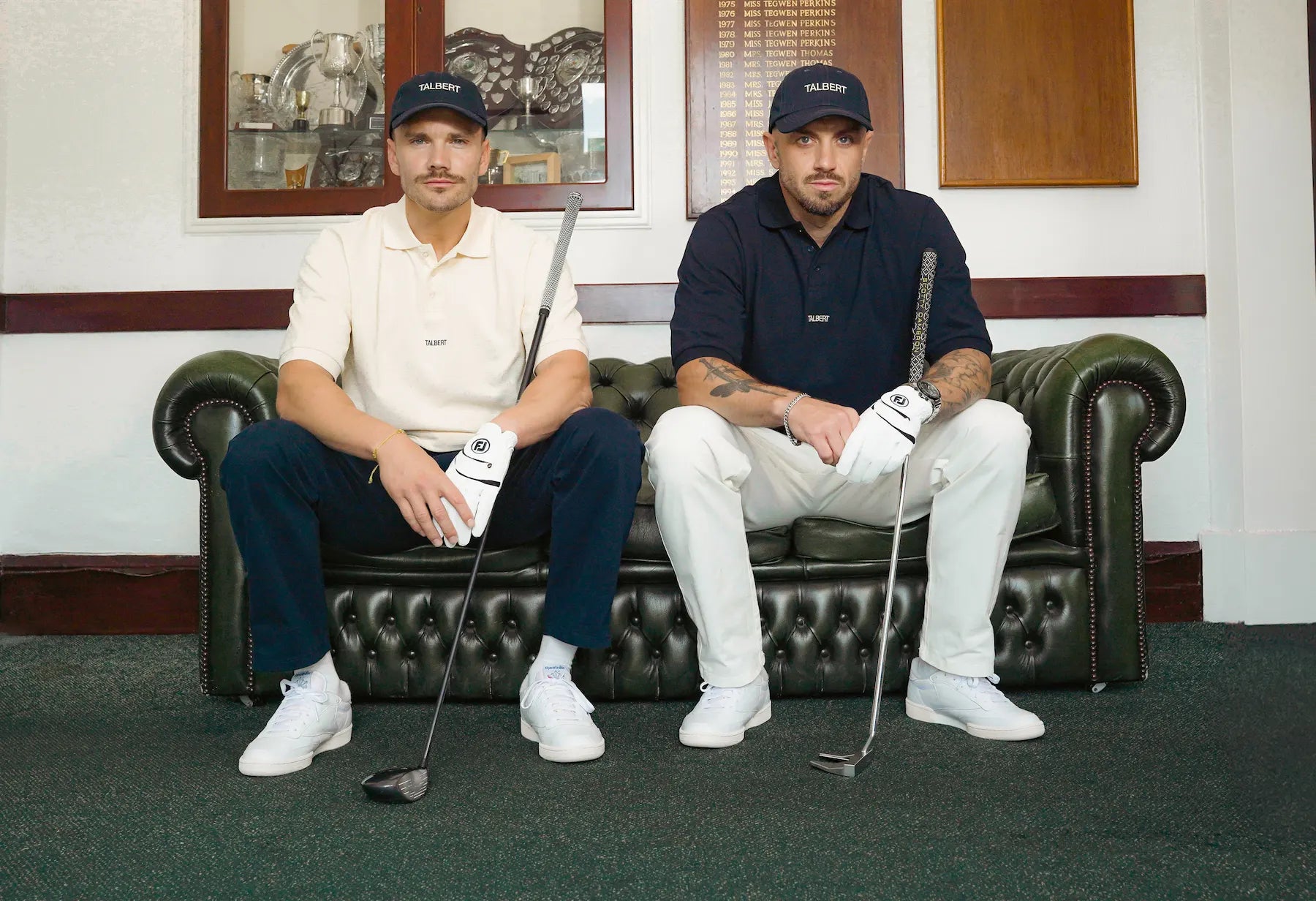 Models wearing Talbert Golf 001 Polo in cream and navy in a golf clubhouse