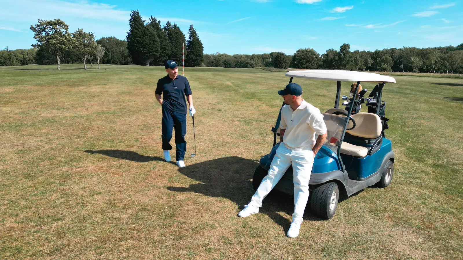 Models wearing Talbert Golf 001 Polo in cream and navy on golf course